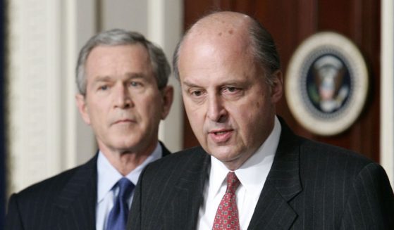 John Negroponte, right, then-U.S. ambassador to Iraq, speaks as then-President George W. Bush looks on at the Eisenhower Executive Office Building of the White House in Washington on Feb. 17, 2005.