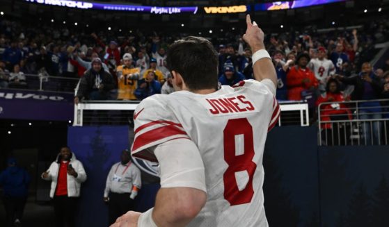 New York Giants quarterback Daniel Jones runs off the field after leading his team to a 31-24 victory over the Minnesota Vikings in an NFC wild-card playoff game Sunday at U.S. Bank Stadium.