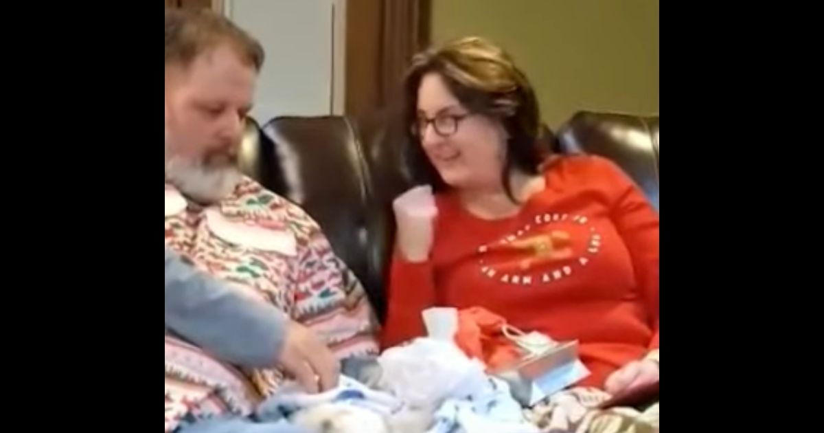 Nick and Shaina Day open a very special Christmas gift.