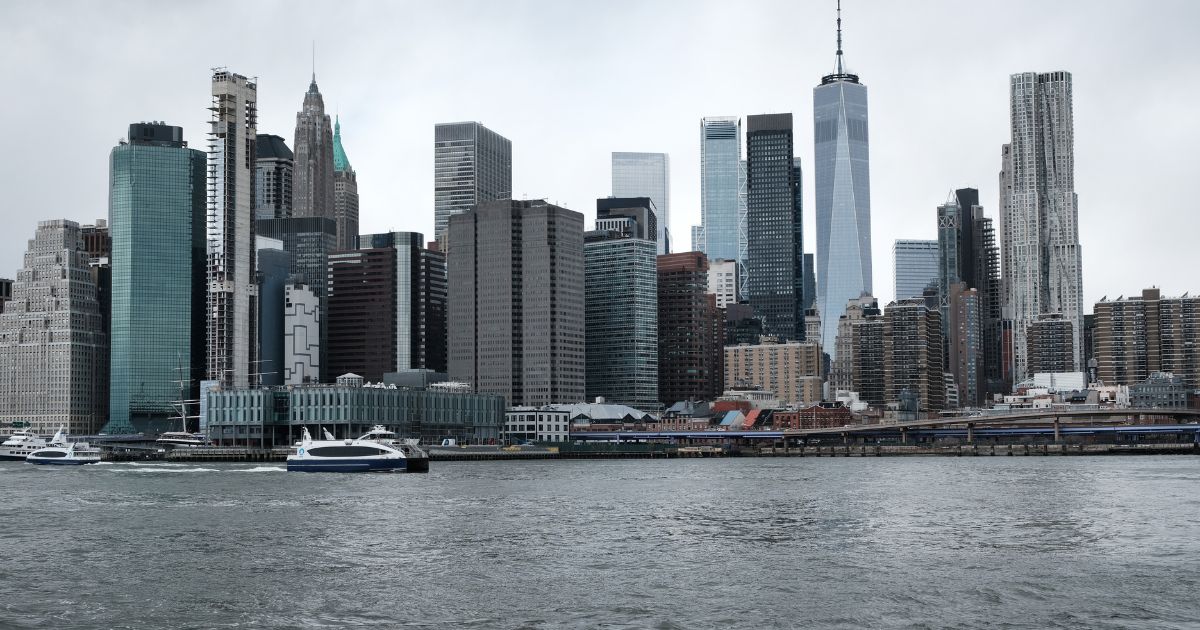 The Manhattan skyline is visible across the East River in New York City on March 28, 2022.