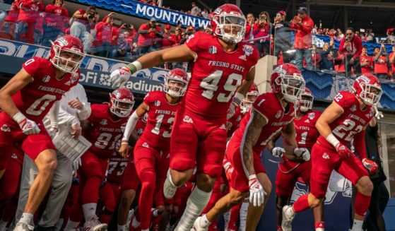 The Fresno State Bulldogs run out of the tunnel at the beginning of their LA Bowl contest against Washington State at SoFi Stadium in Los Angeles on Dec. 17. Fresno State won 29-6.