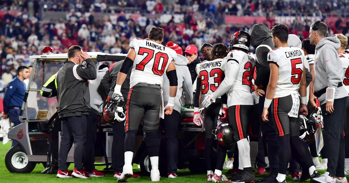 Tampa Bay Buccaneers wide receiver Russell Gage is surrounded by his teammates as he is carted off the field after suffering an injury during the fourth quarter of a wild-card playoff game against the Dallas Cowboys at Raymond James Stadium on Monday night.