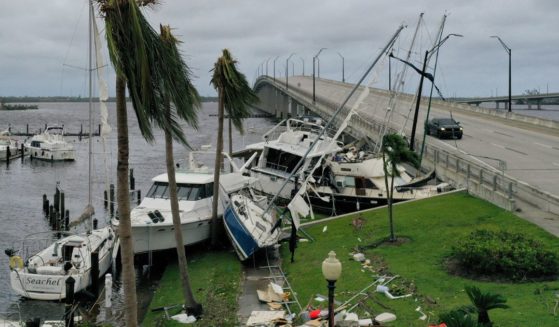 Boats are pushed up on a causeway in Fort Meyers, Florida, following Hurricane Ian.