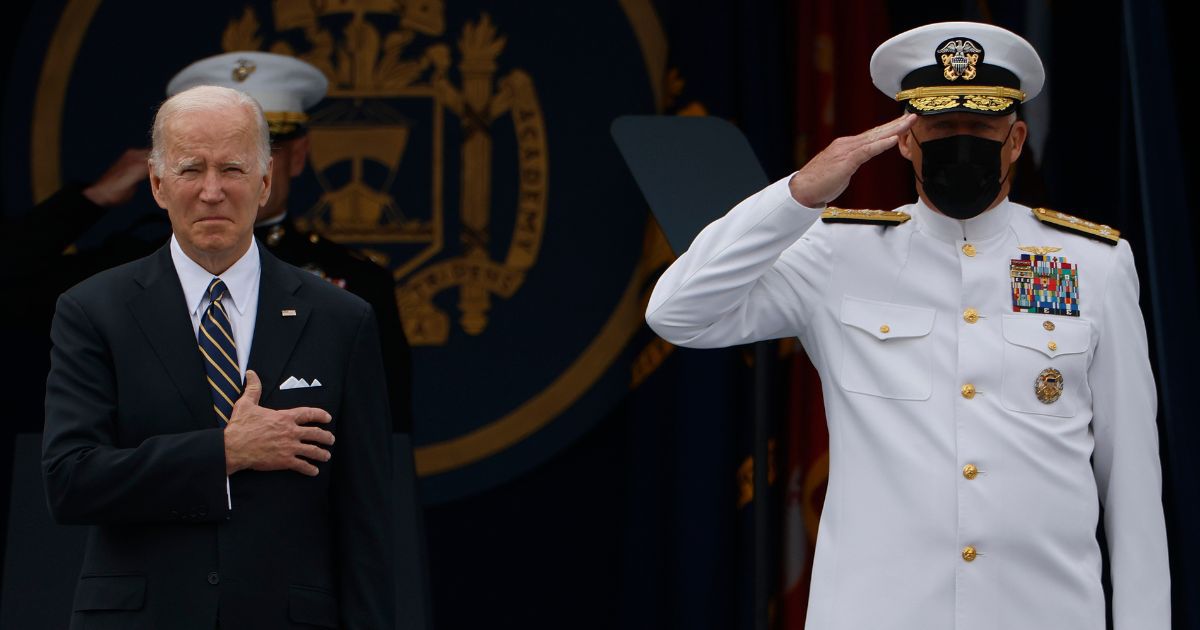 President Joe Biden and Naval Academy Superintendent Vice Admiral Sean Buck stand for the national anthem during the graduation and commissioning ceremony at the U.S. Naval Academy Memorial Stadium in Annapolis, Maryland, on May 27.