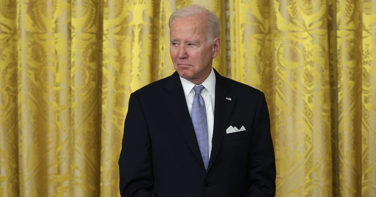 President Joe Biden listens during an event in the East Room of the White House on Friday.