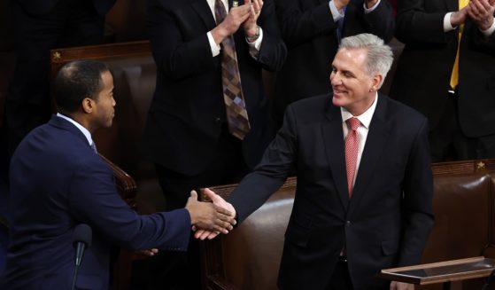 U.S. House Republican Leader Kevin McCarthy shakes hands with Rep.-elect John James in the House Chamber during the third day of elections for Speaker of the House at the U.S. Capitol Building on January 05, 2023 in Washington, DC.