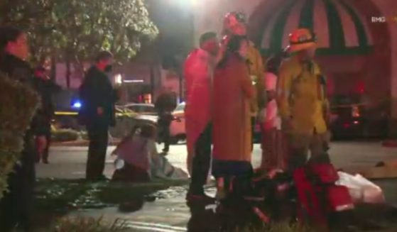 First responders and victims stand outside a dance club where a shooting took place during a Lunar New Year celebration in Monterey Park, California, on Saturday night.