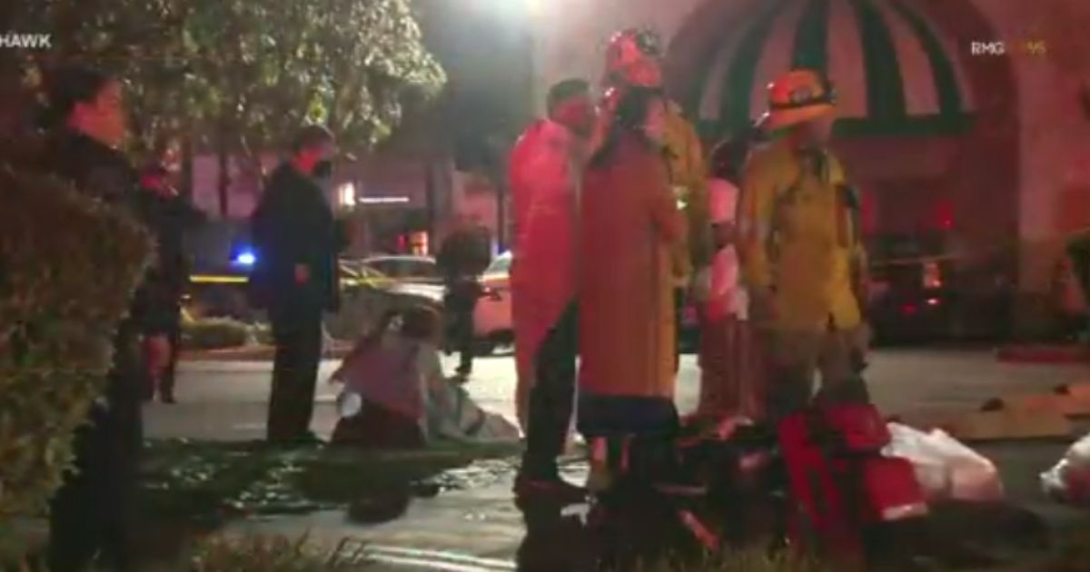 First responders and victims stand outside a dance club where a shooting took place during a Lunar New Year celebration in Monterey Park, California, on Saturday night.