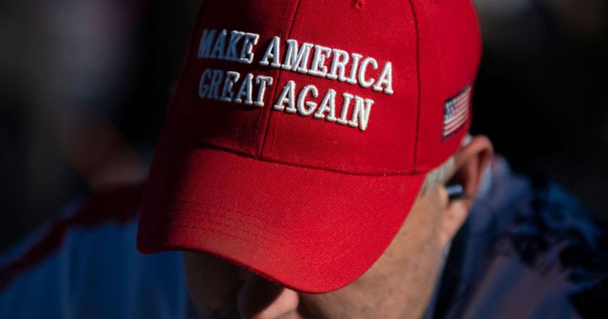 An attendee wearing a MAGA hat waits before former President Donald Trump speaks during a "Save America" rally in Conroe, Texas, on Jan. 29, 2022.