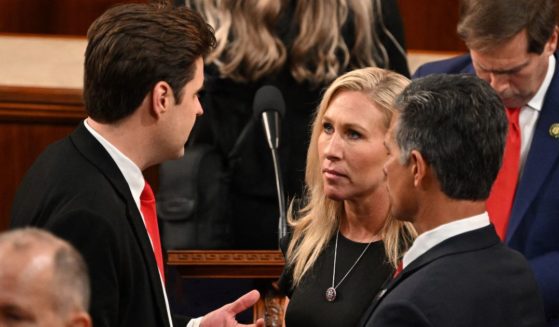 GOP Rep. Marjorie Taylor Greene, center, speaks with Rep. Matt Gaetz, left, on the House floor of the U.S. Capitol as the 118th Congress convenes on Tuesday. Gaetz and 19 other Republicans blocked Kevin McCarthy from becoming speaker of the House, a choice which angered Greene.