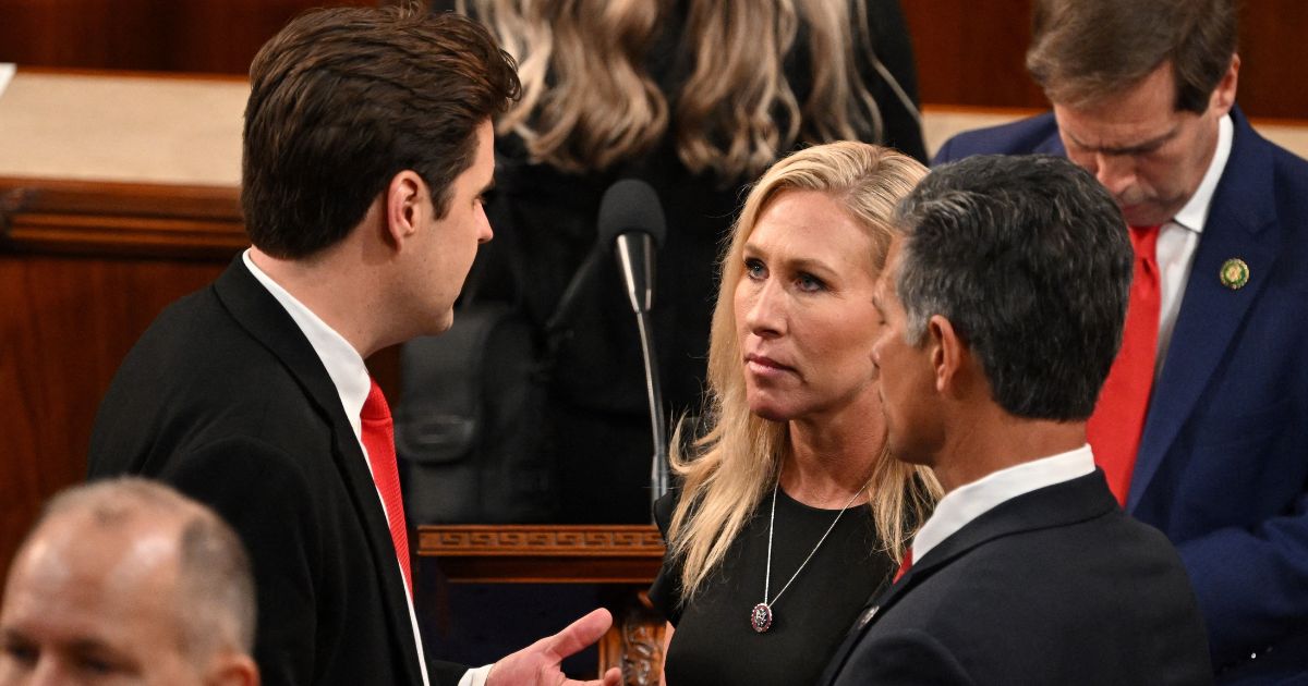 GOP Rep. Marjorie Taylor Greene, center, speaks with Rep. Matt Gaetz, left, on the House floor of the U.S. Capitol as the 118th Congress convenes on Tuesday. Gaetz and 19 other Republicans blocked Kevin McCarthy from becoming speaker of the House, a choice which angered Greene.