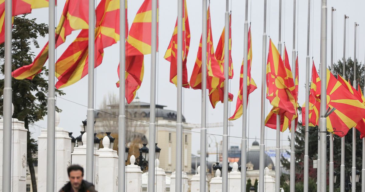Northern Macedonia government flags fly at half mast in capital Skopje, Northern Macedonia, on Nov. 23, 2021.