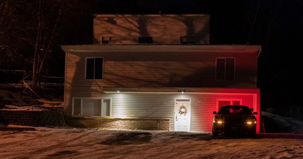 A private security officer sits in a vehicle on Tuesday in front of the house in Moscow, Idaho, where four University of Idaho students were killed in November 2022.