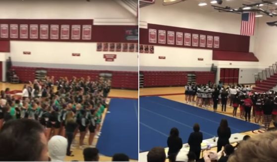 When the recording wouldn't play, the cheerleading teams joined together in singing the national anthem.