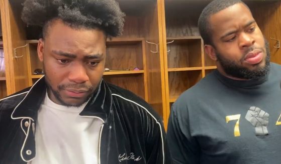 Joseph Ossai, left, standing in front of his locker inside Arrowhead Stadium in Kansas City, with Cincinnati Bengals teammate B.J. Hill standing by for support, answers questions after the team's loss to the Chiefs.