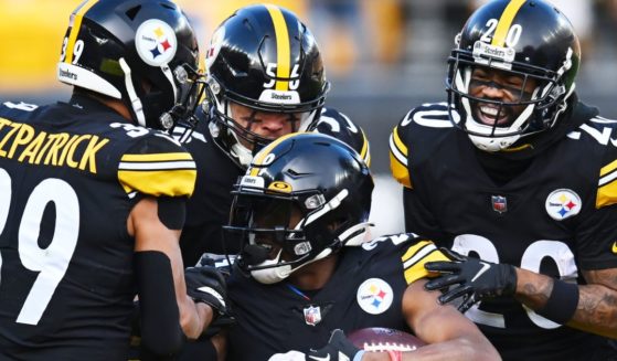 Pittsburgh Steelers defensive players, including Alex Highsmith #56, center, celebrate an interception during the second quarter against the Cleveland Browns in Pittsburgh, Pennsylvania, on Sunday.