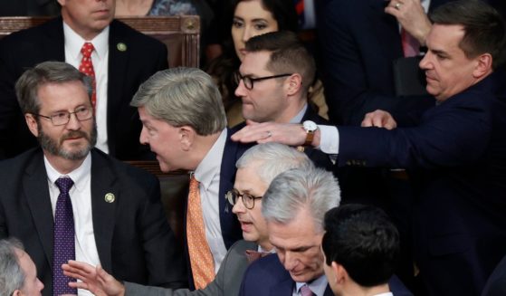 Rep. Mike Rogers of Alabama , center, is restrained by Rep. Richard Hudson of North Carolina after getting into an argument with Florida Rep. Matt Gaetz in the House chamber during the fourth day of elections for speaker of the House on Friday in Washington, D.C.