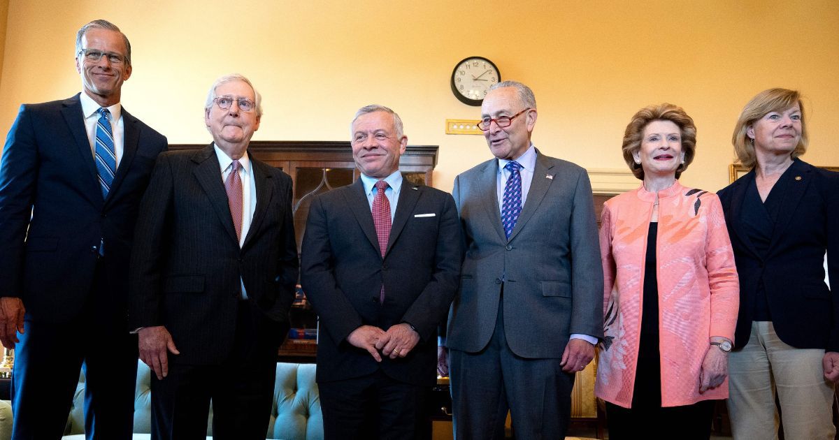 Democratic Sen. Debbie Stabenow of Michigan, second from right, stands with, from left, Sen. John Thune, Senate Minority Leader Mitch McConnell, King Abdullah II of Jordan, Senate Majority Leader Chuck Schumer and Sen. Tammy Baldwin at the U.S. Capitol in Washington on May 10.