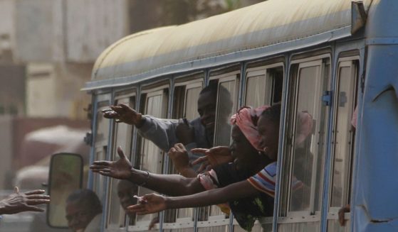 Passengers ride in a public passenger bus in Dakar, Senegal, on March 21, 2012.