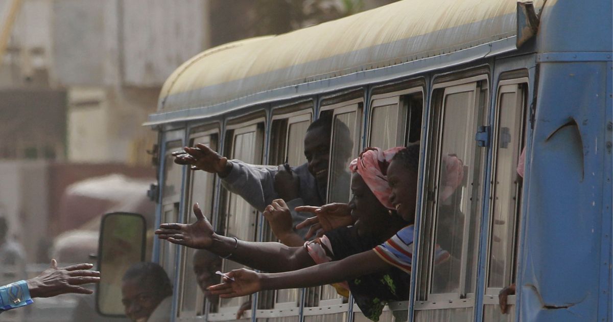 Passengers ride in a public passenger bus in Dakar, Senegal, on March 21, 2012.