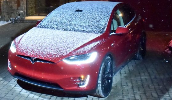 A Tesla covered in snow is parked outside the WanderLuxe House in Park City, Utah, on January 22, 2018.