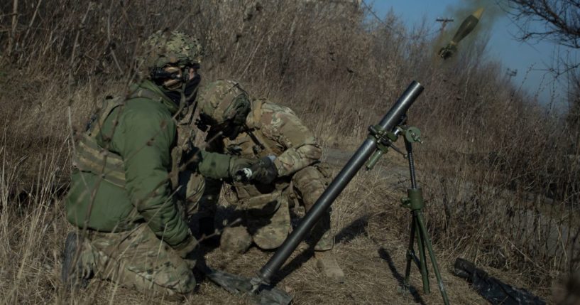 Ukrainian military members fire a mortar in Bakhmut, Ukraine, on Friday.