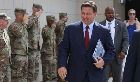 Florida Gov. Ron DeSantis arrives for a bill-signing ceremony at the Florida National Guard armory on June 7, 2021, in Miami. The governor signed the bills to combat foreign influence. Now he's activated the National Guard to deal with immigration problems in the state.