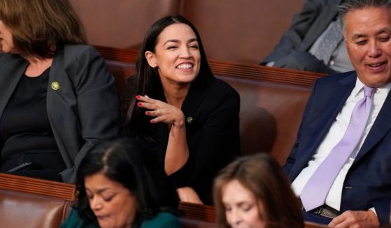 Democratic Rep. Alexandria Ocasio-Cortez smiles as votes are cast in the House chamber on Jan. 4 for the speaker position of the 118th Congress.