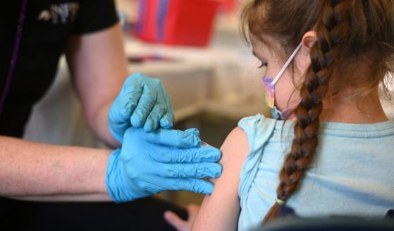 A nurse administers the COVID-19 vaccine to a young girl at a L.A. Care Health Plan vaccination clinic at Los Angeles Mission College in the Sylmar neighborhood of Los Angeles on Jan. 19, 2022.