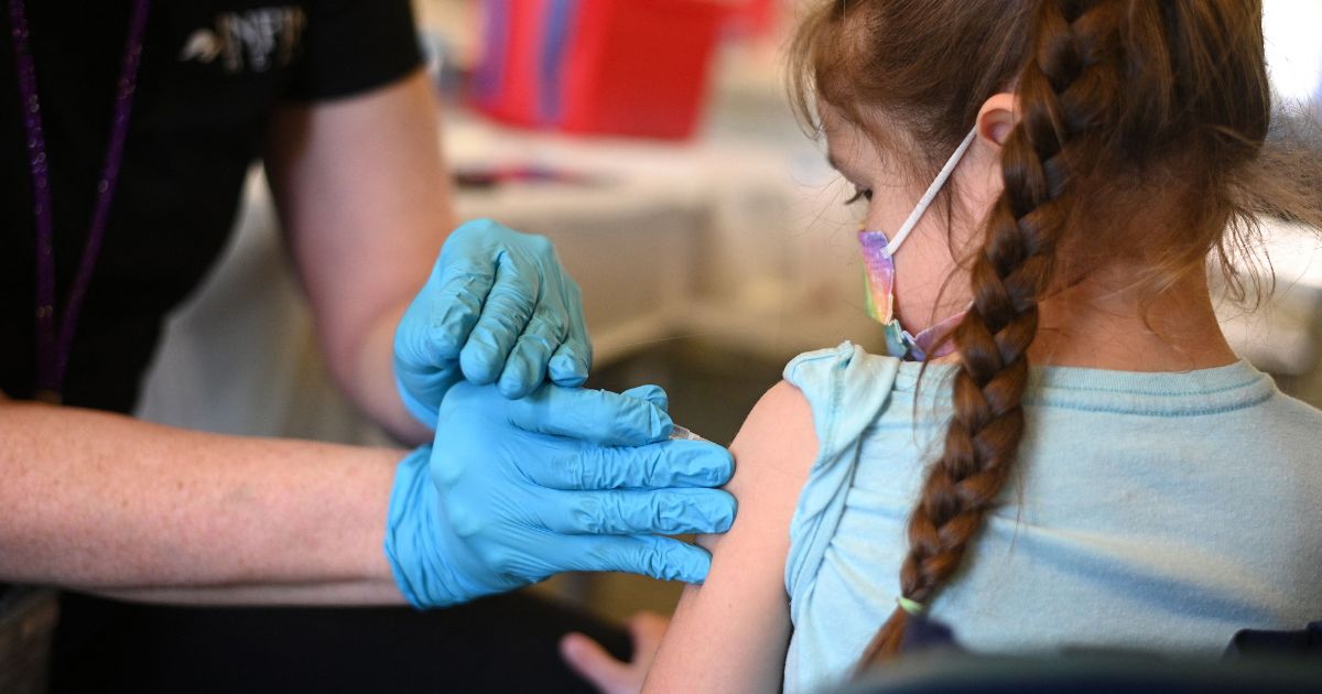 A nurse administers the COVID-19 vaccine to a young girl at a L.A. Care Health Plan vaccination clinic at Los Angeles Mission College in the Sylmar neighborhood of Los Angeles on Jan. 19, 2022.