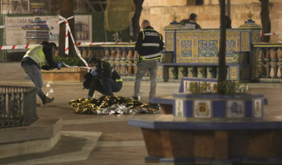 Police in Algeciras, Spain, work next to the body of a man who was killed during an attack on a local church on Wednesday.