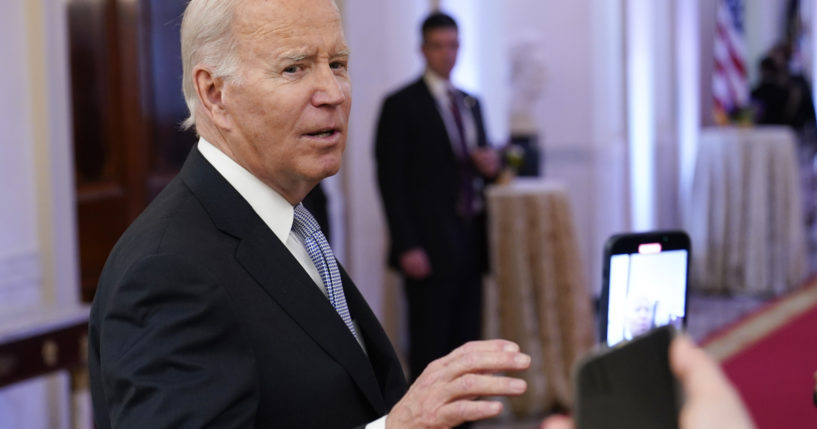President Joe Biden talks with reporters after speaking in the East Room of the White House on Friday.