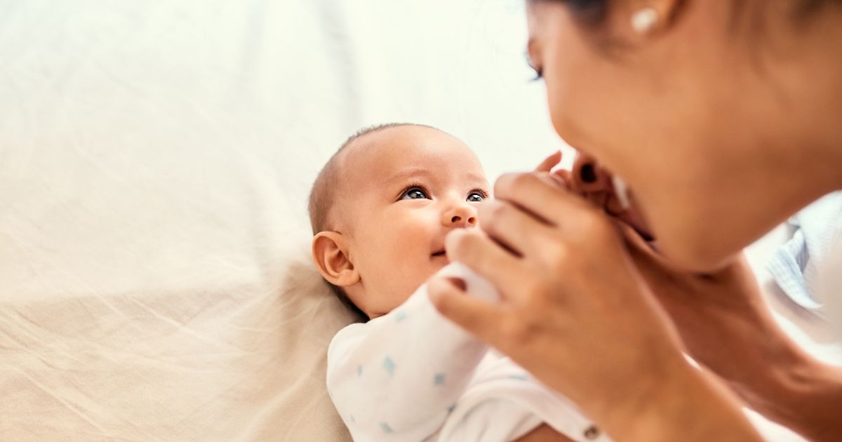 A mother plays with her baby in the above stock image.