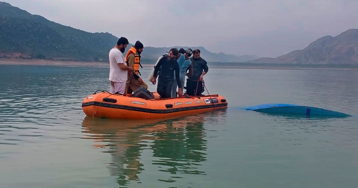 In this photo provided by Khyber Pakhtunkhwa's provincial rescue department "Rescue 1122," rescue workers search bodies following a boat caspase in Tanda lake, in Kohat, in the northwest Pakistan on Sunday.