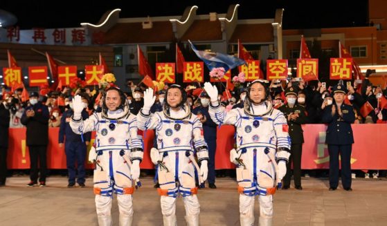 (From R) Chinese astronauts Fei Junlong, Deng Qingming and Zhang Lu, crew of the Shenzhou-15 spaceflight mission, wave during a ceremony prior to the launch of the Shenzhou-15 mission at the Jiuquan Satellite Launch Center in Northwest Chinas Gansu Province on November 29, 2022.