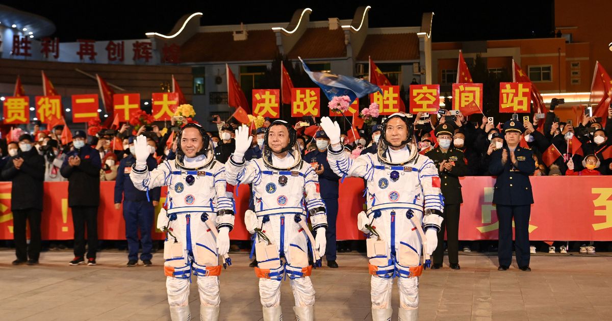 (From R) Chinese astronauts Fei Junlong, Deng Qingming and Zhang Lu, crew of the Shenzhou-15 spaceflight mission, wave during a ceremony prior to the launch of the Shenzhou-15 mission at the Jiuquan Satellite Launch Center in Northwest Chinas Gansu Province on November 29, 2022.