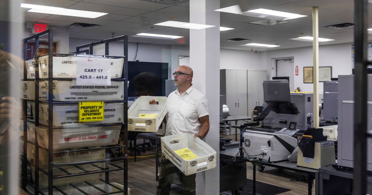 Employees of the Miami Dade County of elections department begin counting mail in ballots on November 8, 2022 in Miami.
