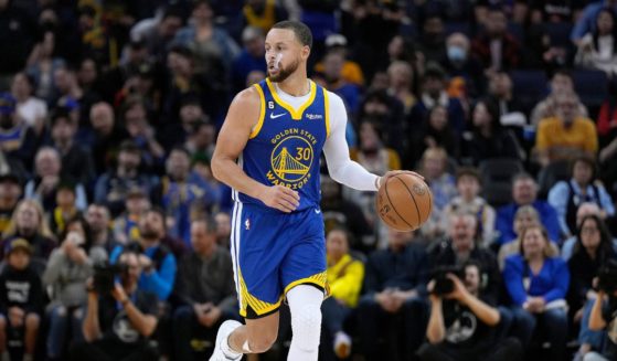 Stephen Curry of the Golden State Warriors dribbles the ball up the court against the Toronto Raptors during the fourth quarter of an NBA basketball game in San Francisco on Friday.