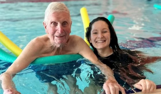 Roget Roberts and care assistant Holli Whitehouse swim together at the Wyre Forest Leisure Centre in Kidderminster, England. This is the first time in 80 year that the World War II veteran has gone swimming.