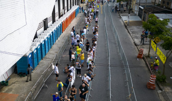 Soccer fans line up Monday to attend the funeral of the late Brazilian soccer legend Pele at the Vila Belmiro stadium in Santos, Brazil.