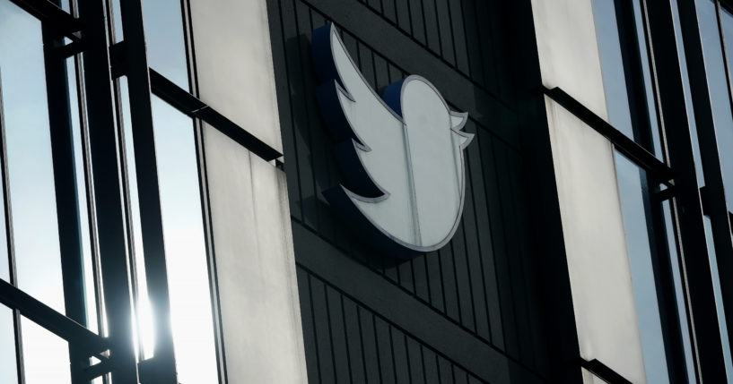 A Twitter logo hangs outside the company's offices in San Francisco, California, on Dec. 19.