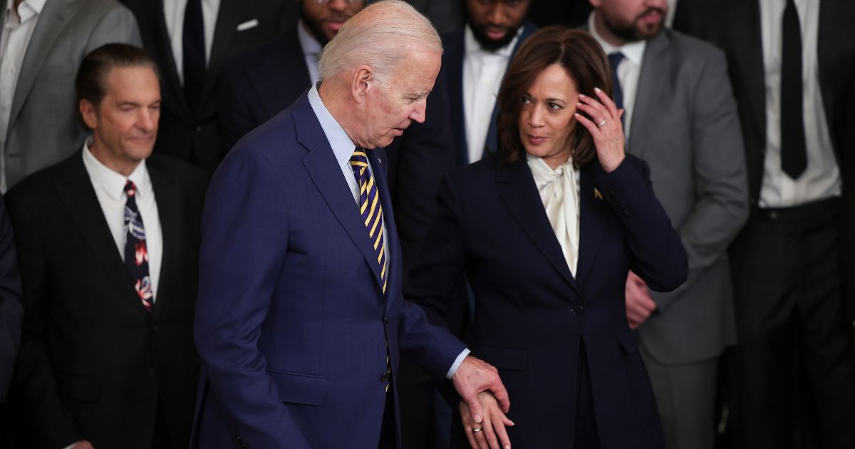 Joe Biden holds hands with Kamala Harris during a ceremony honoring the Golden State Warriors on January 17, 2023 in Washington, DC.
