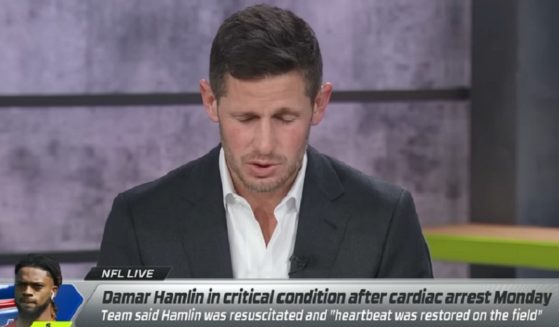 ESPN analyst and former NFL quarterback Dan Orlovsky bows his head in prayer on "NFL Live" on Tuesday.