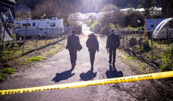FBI officials walk towards the crime scene at Mountain Mushroom Farm on Tuesday after a gunman killed several people at two agricultural businesses in Half Moon Bay, California.