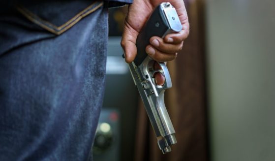 A man holding a handgun is featured in this stock photo.