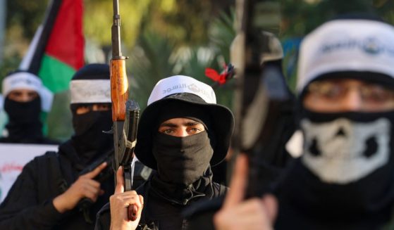 Palestinians Hamas militants wearing headbands reading in Arabic "the Lion's Den", in reference to the Nablus based Lion's Den armed group (Areen Al-Asood), a loose coalition of fighters not aligned with established Palestinian factions, march in support of the group in Gaza City on December 10, 2022.