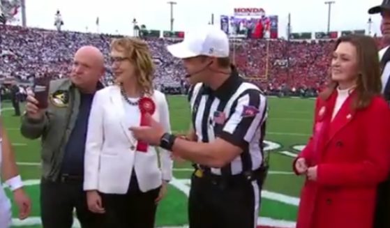 Sen. Mark Kelly of Arizona videos the coin toss of Monday's Rose Bowl.
