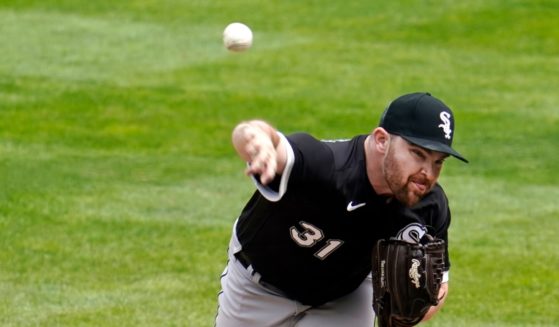 Chicago White Sox pitcher Liam Hendriks throws against the Minnesota Twins in the ninth inning of a game in May 2021.