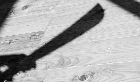 The shadow of a machete is seen in this stock image.
