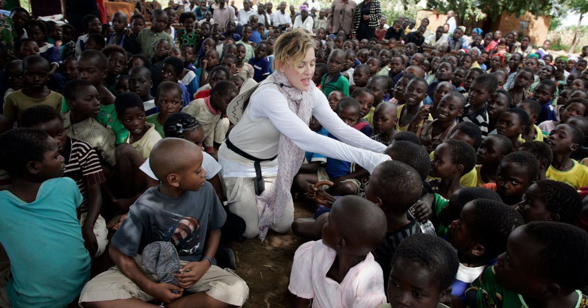 Madonna, center, interacts with Malawian children at Mkoko Primary School on April 2, 2013, in the region of Kasungu, Malawi.
